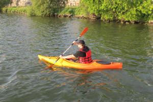 A kayaker paddling an Open Cockpit kayak