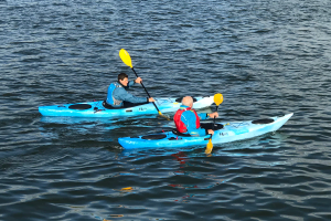 Kayakers paddling short touring kayaks in the UK