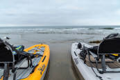 Pair of Hobie Lynx resting on a beach