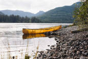 Nova Craft Prospector 16, lightweight Canadian canoe on the water with a fishing rod