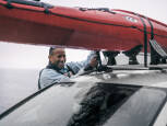 Kayak being tied to a roofrack while resting in the Thule DockGrip 895